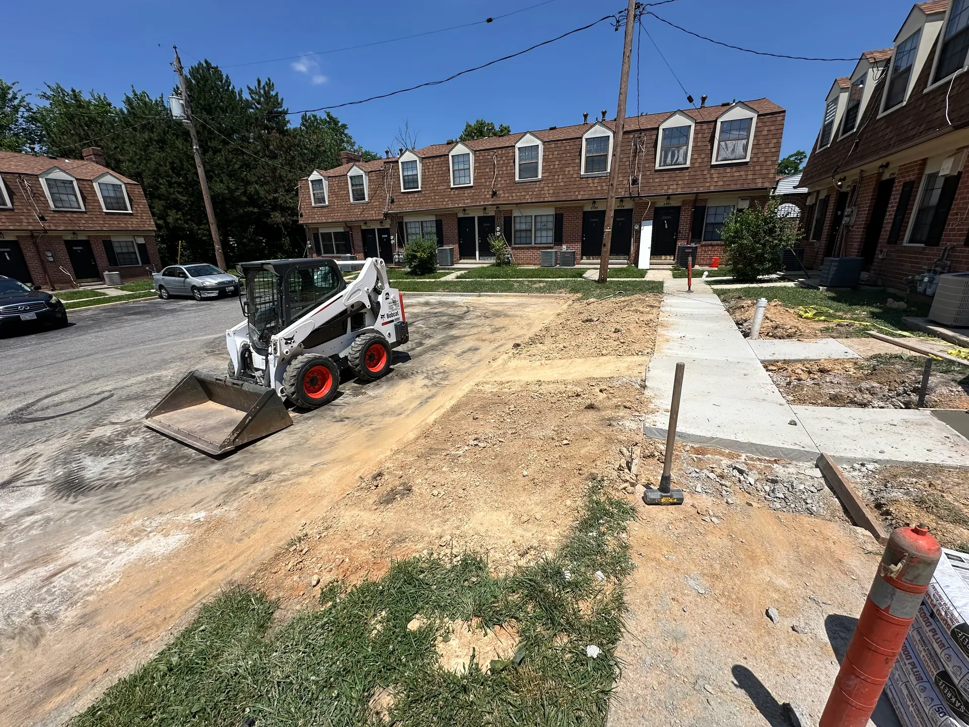 Prism Contracting skid steer grading a residential site ahead of concrete work