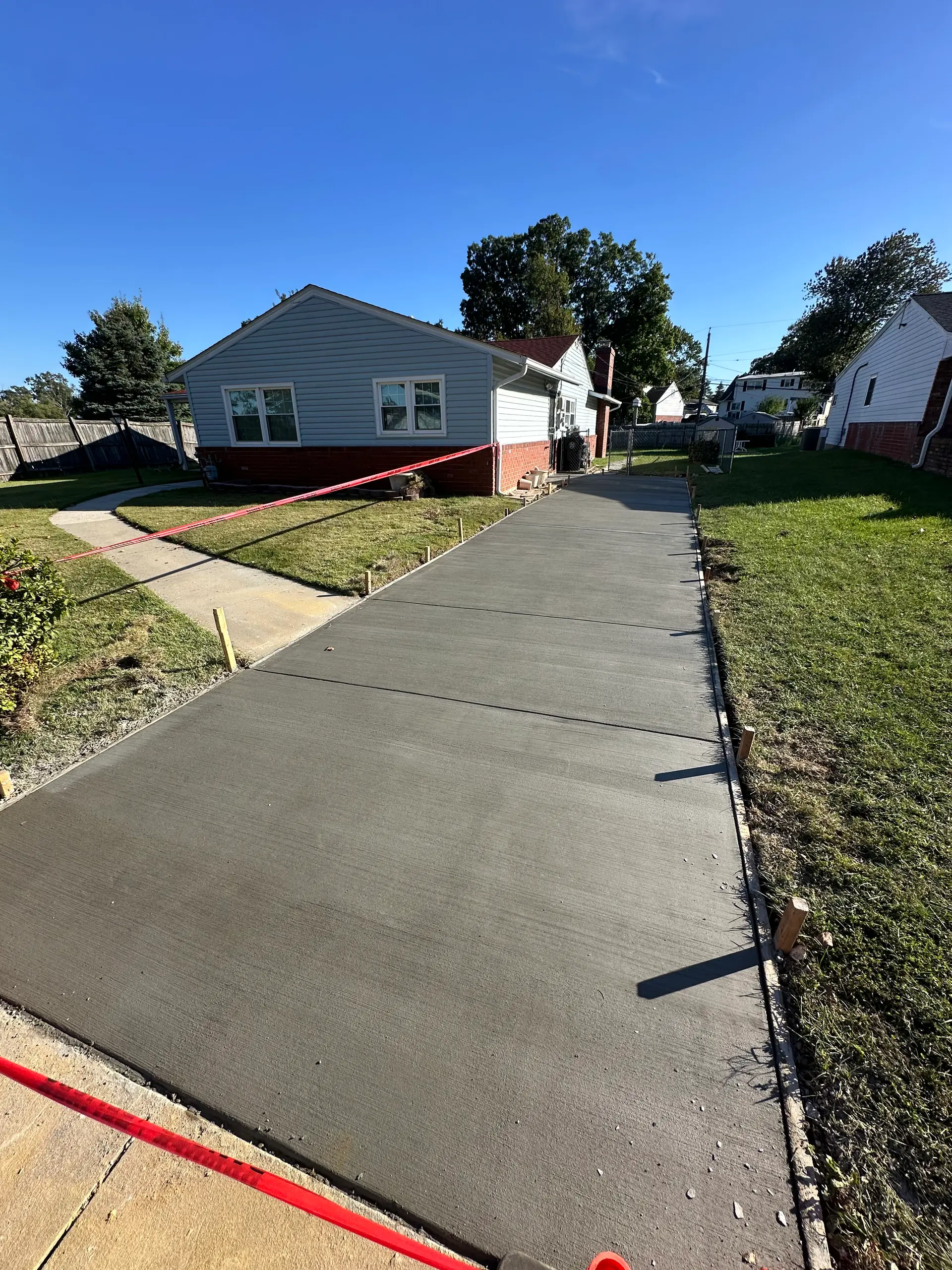 Newly poured concrete driveway, finished project by Prism Contracting