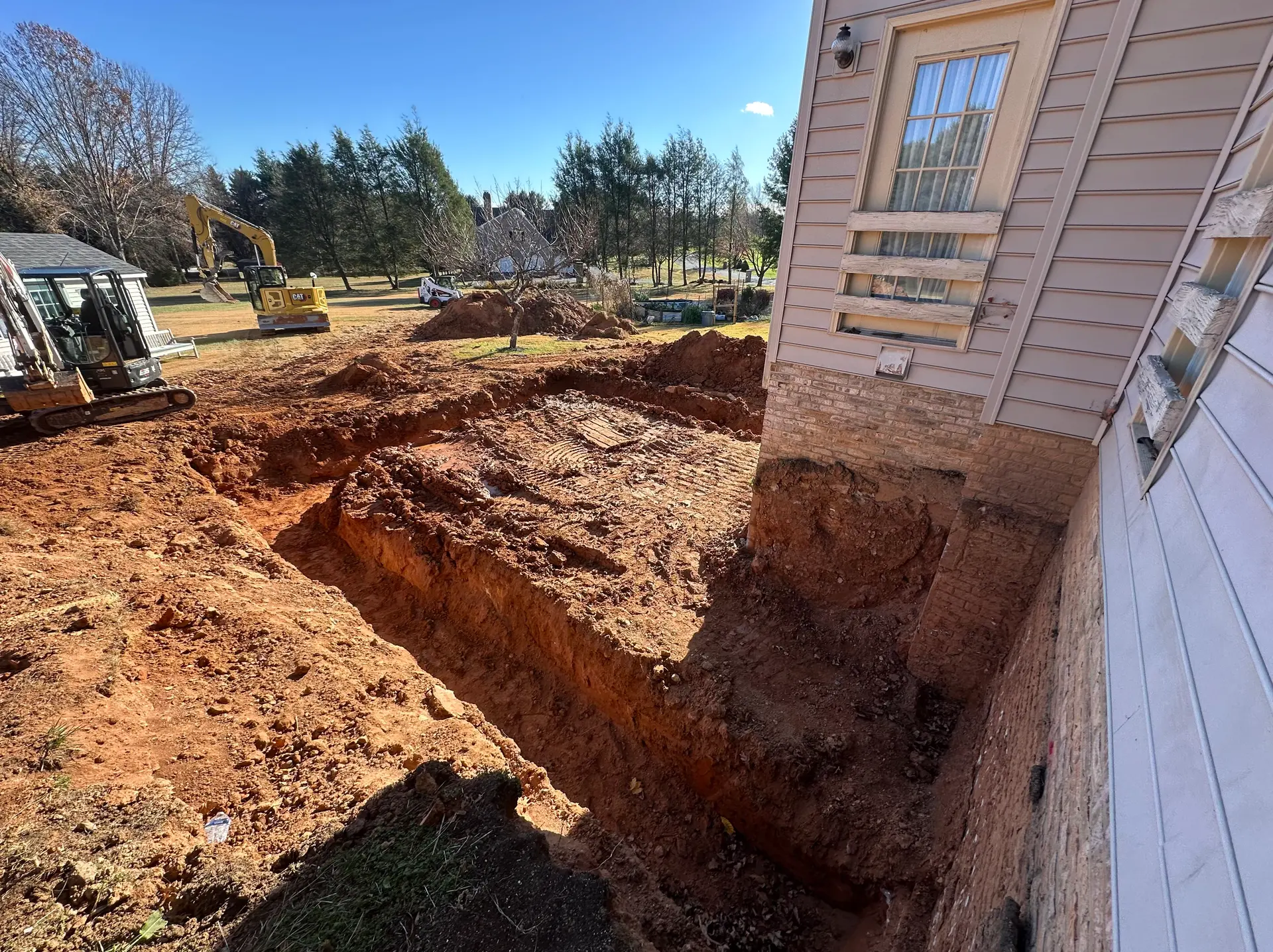 Prism Contracting crew performing residential excavation and grading in Maryland