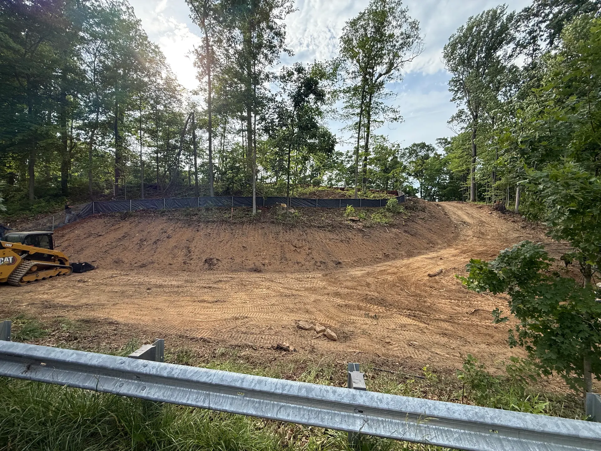 Prism Contracting clearing and grading a wooded Maryland lot for development